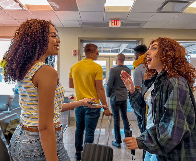 Students chatting at a bus station